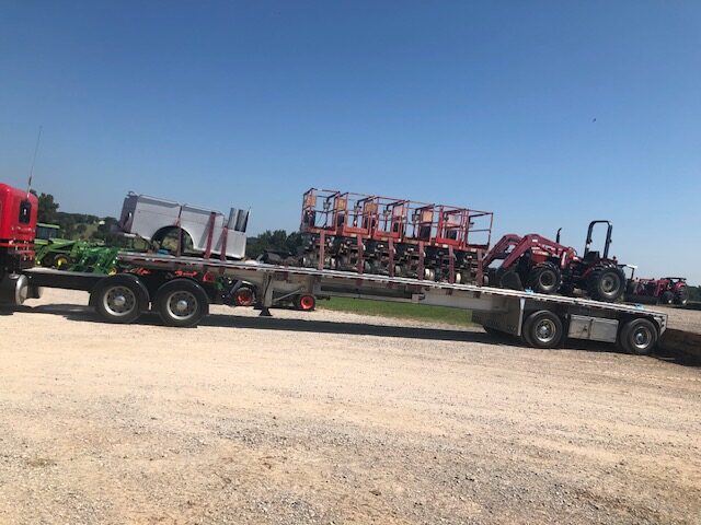 Heavy machinery loaded for secure long distance freight transport.